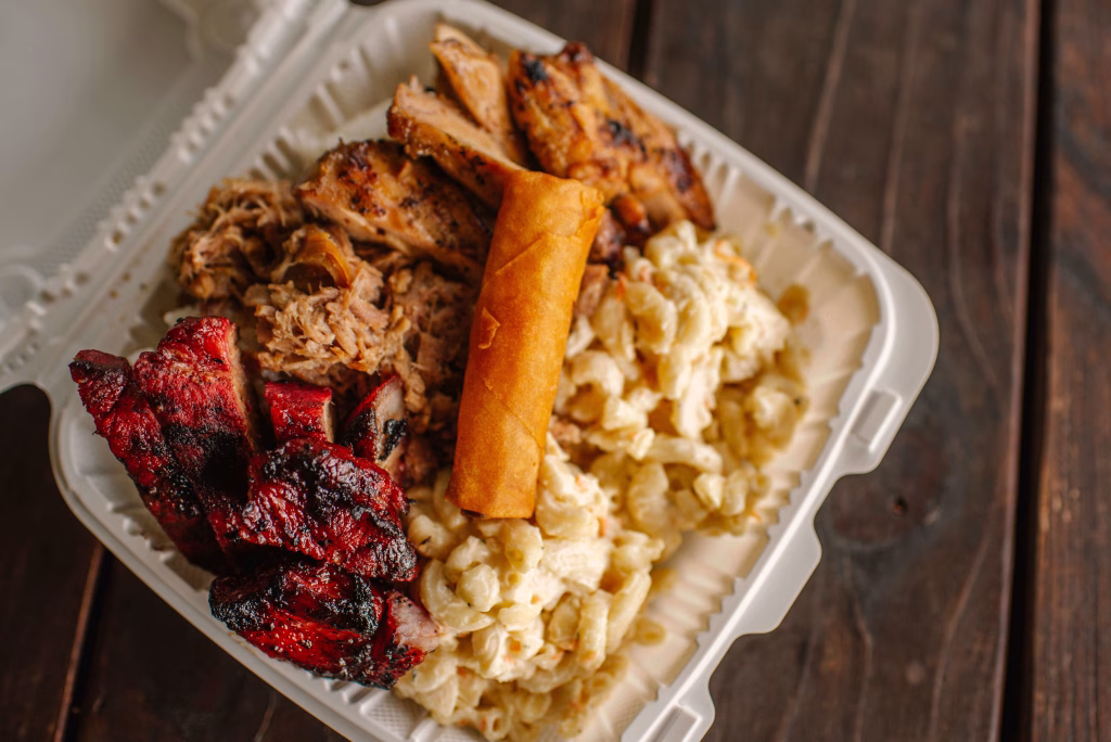 Combo lunch plate with three proteins, homemade Hawaiian mac, fluffy Calrose rice, and crispy chicken egg roll at Wailani in Sutherlin Oregon