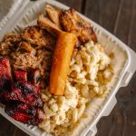 Combo lunch plate with three proteins, homemade Hawaiian mac, fluffy Calrose rice, and crispy chicken egg roll at Wailani in Sutherlin Oregon